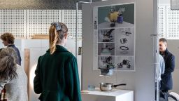 A person in an exhibition space looks at an artwork