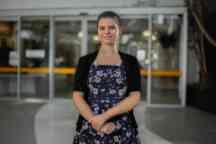 smiling girl in office attire indoor large space