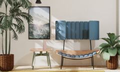 A lounge chair featuring timber and blue cylindrical seat cushions and back support features in a room along with indoor plants and a coffee table