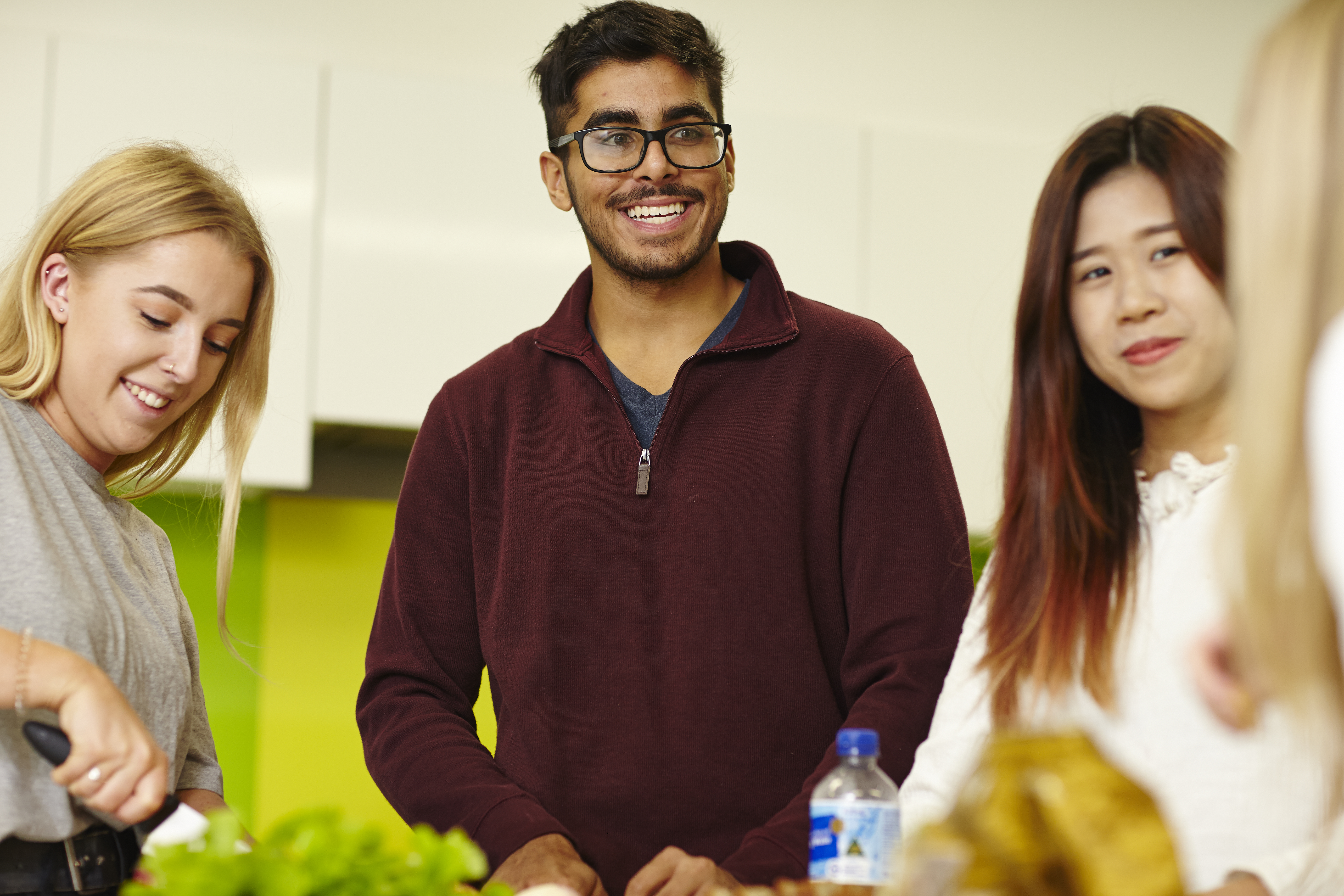 Students gather in the kitchen of their accommodation socialising