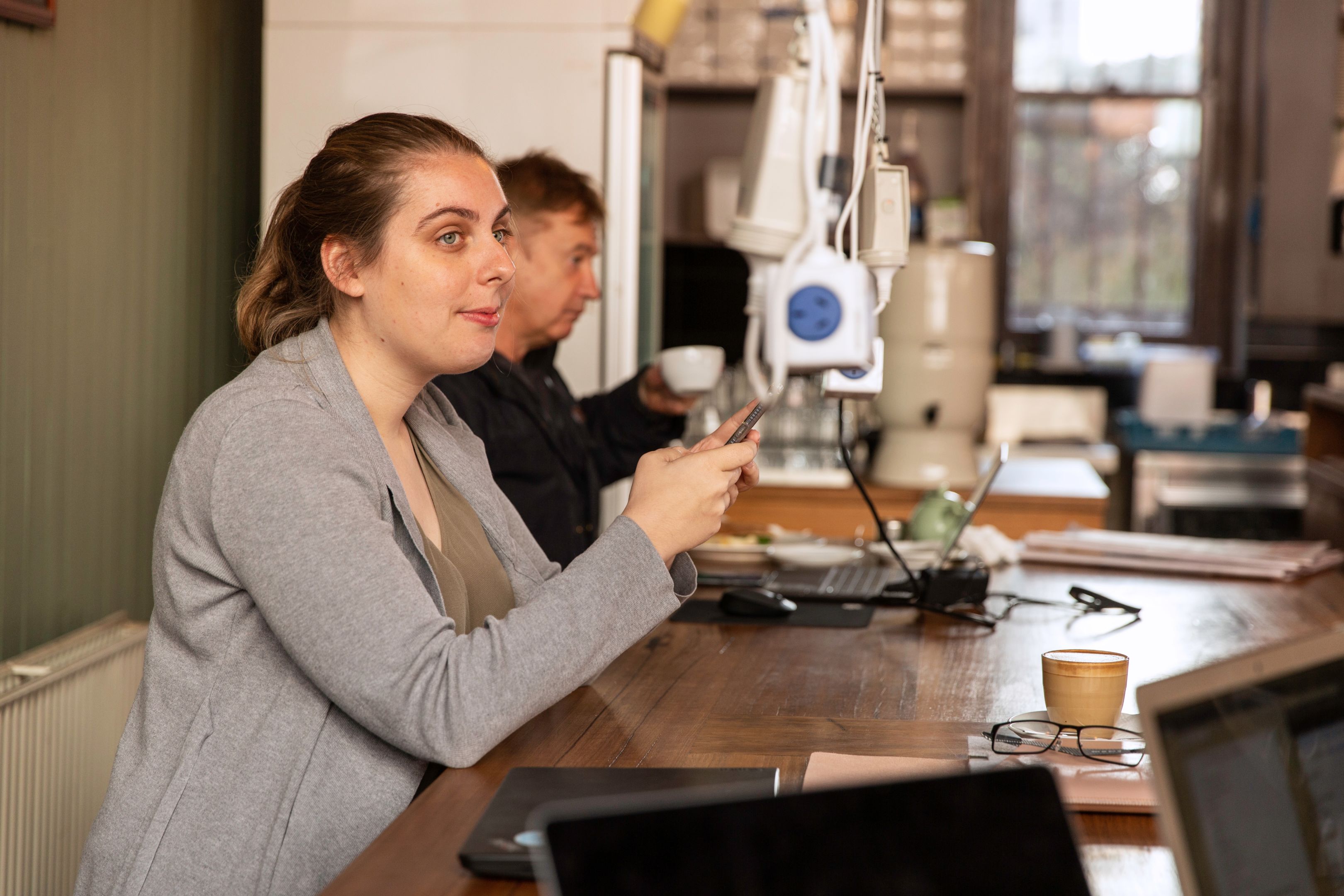 Student on their phone in a cafe