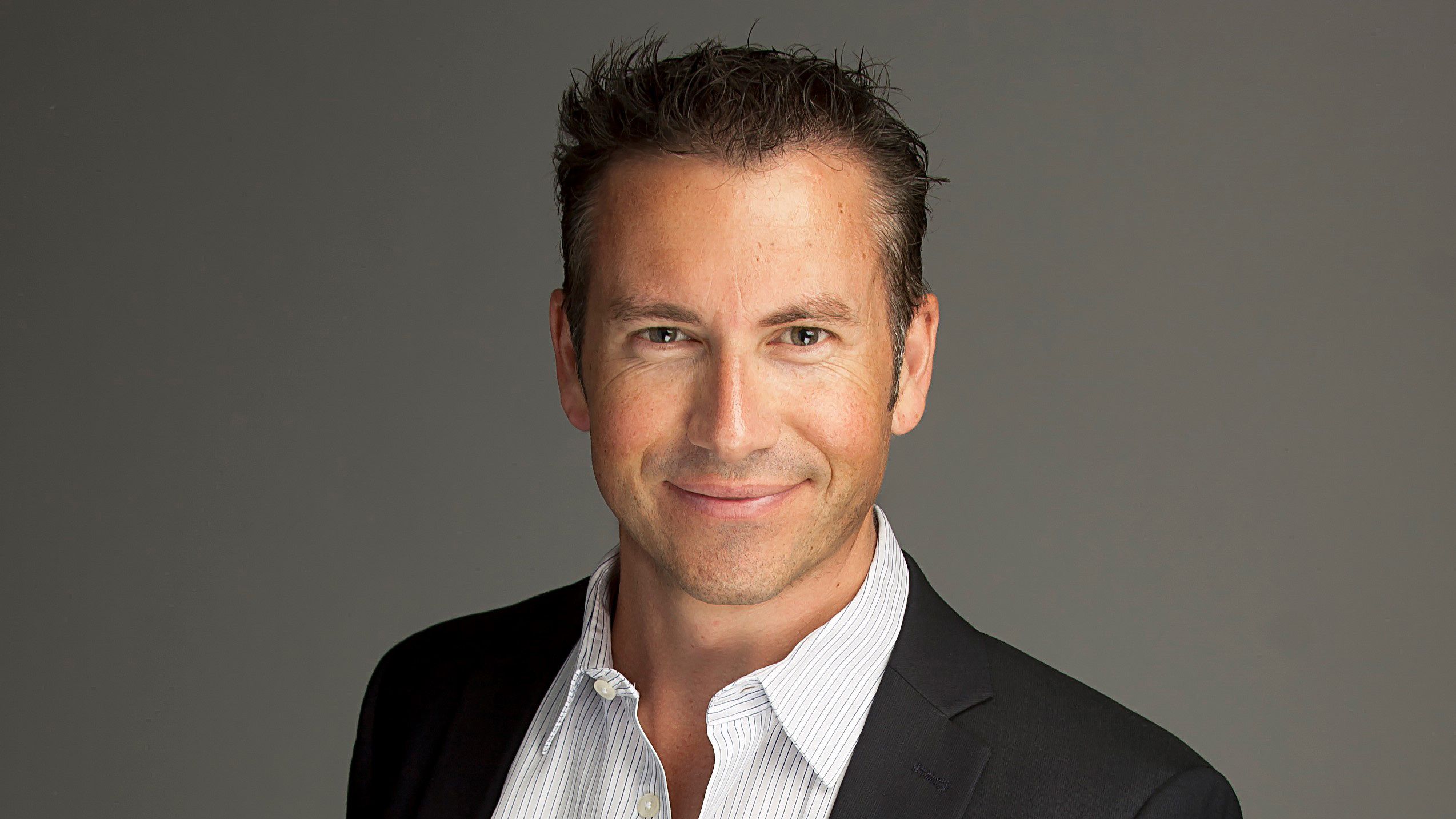 A professional man smiling at camera. 