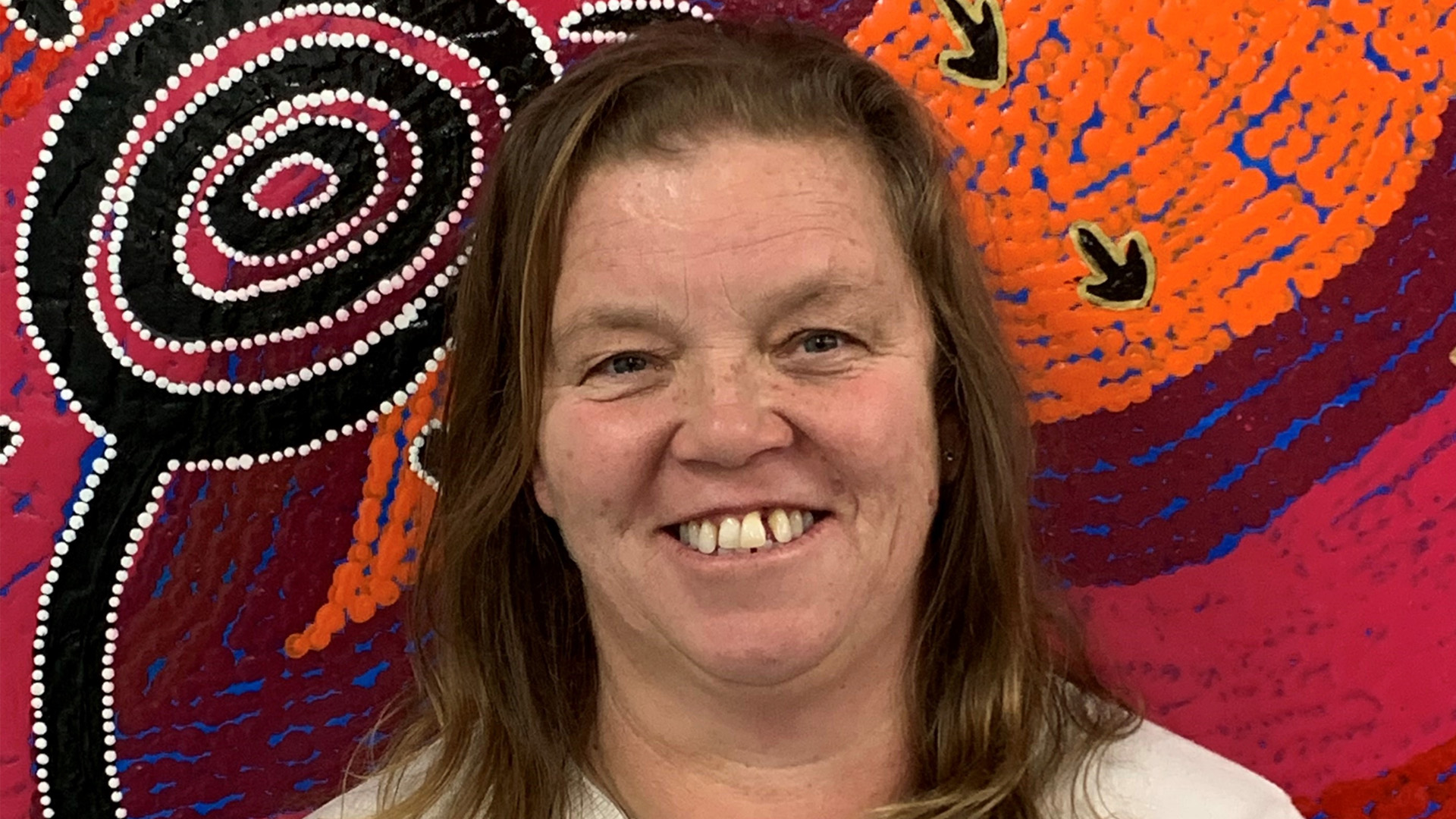 Student photo in front of indigenous artwork