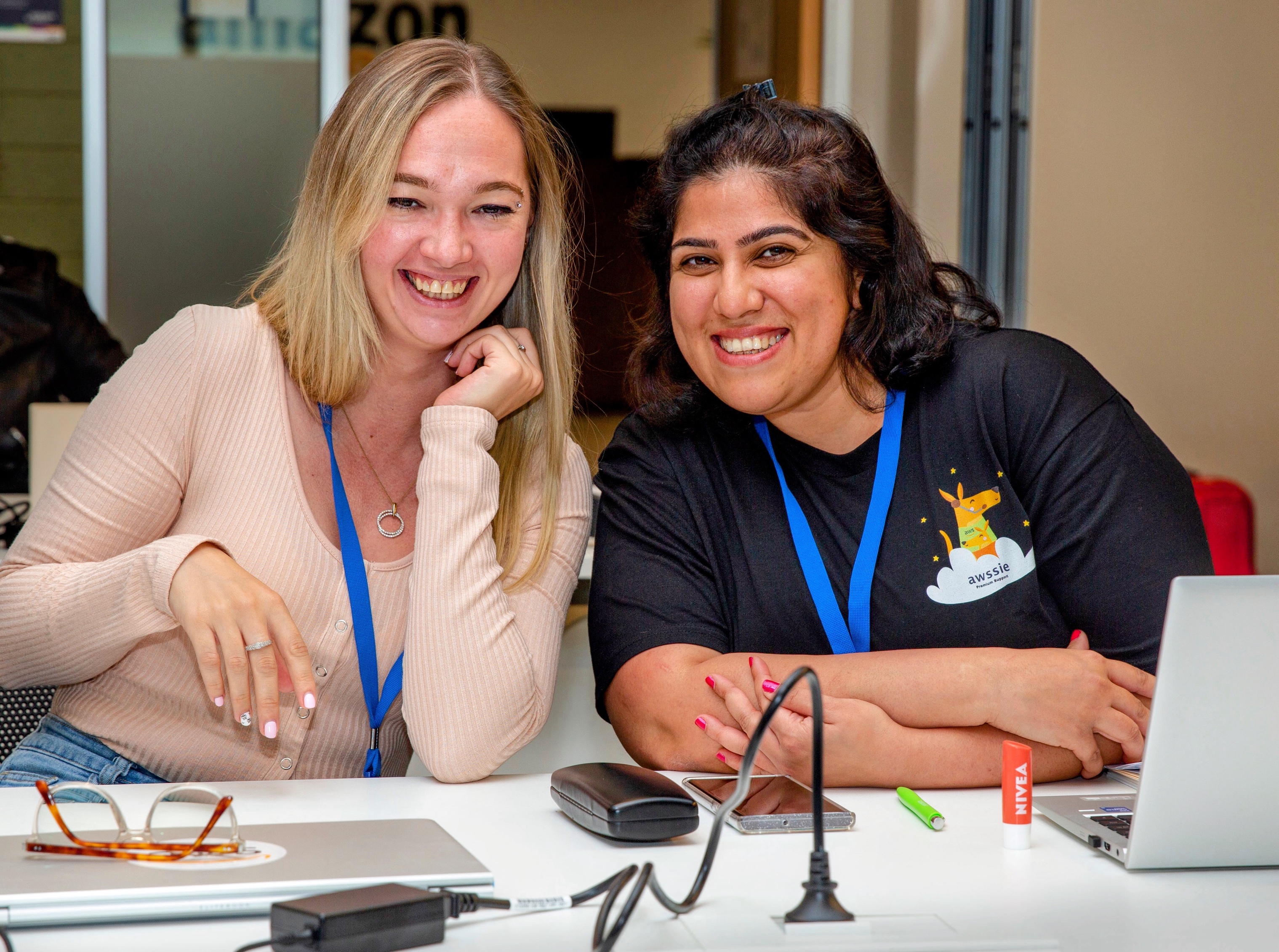 Two young women sitting laughing together