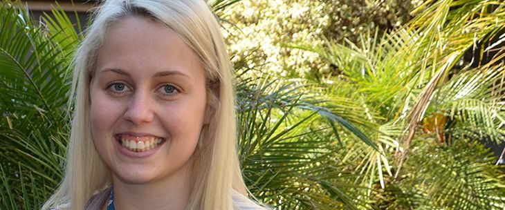 Female with blond hair smiling at the camera