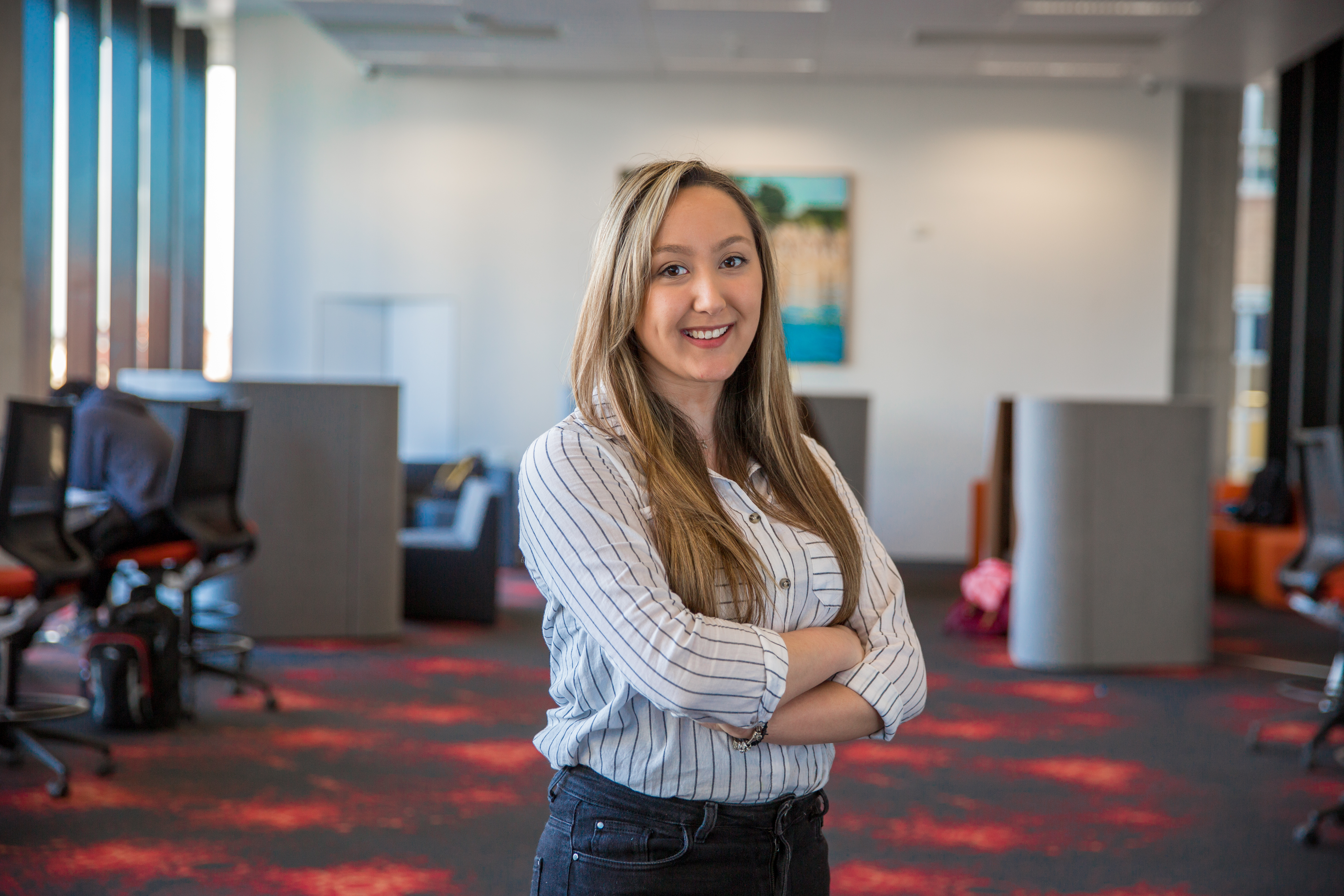 Catherine, a Swinburne student standing in a study room.