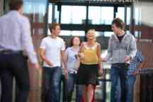 Group of students walk and talk 