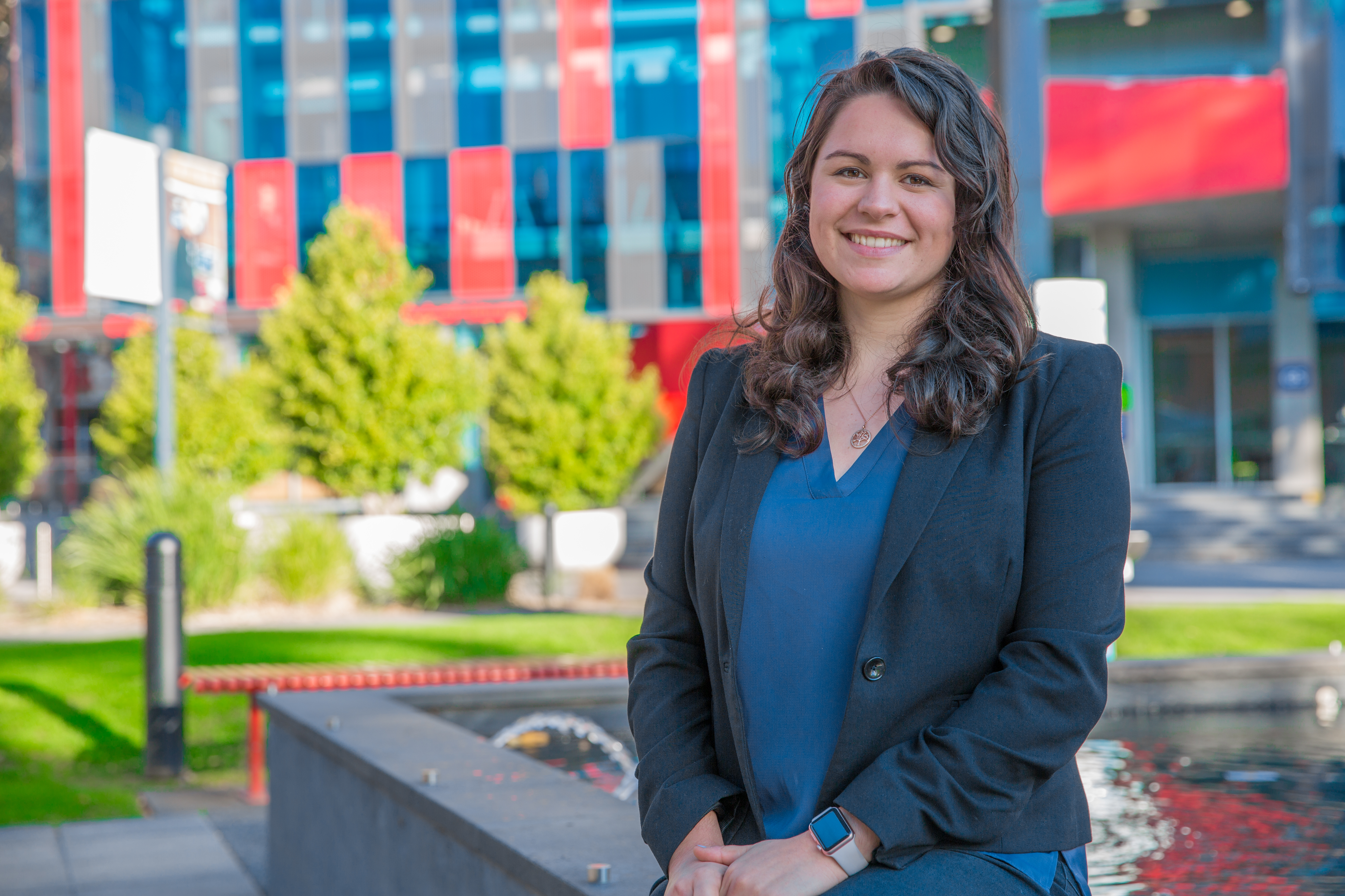 female student smiling in front of GS building