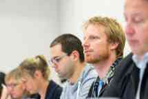 Short course students listen to their tutor in the classroom
