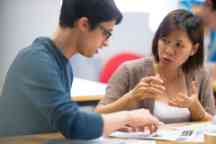 Teacher helps a student understand a topic