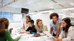 Health staff professionals in an office discussing business paperwork. 