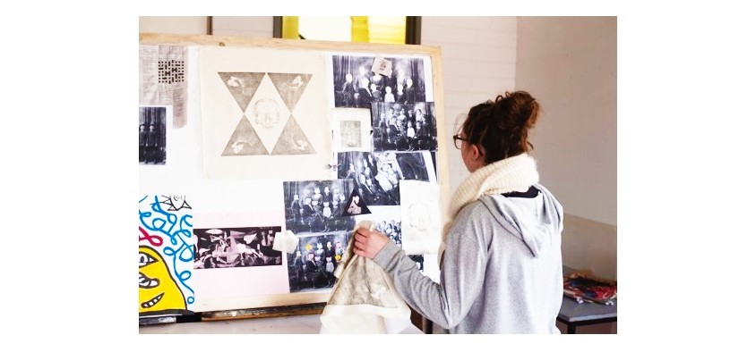 Visual arts student with their work